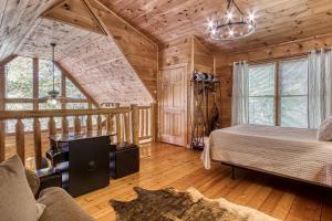 een slaapkamer in een blokhut met een bed en een bureau bij Dog Friendly, Quiet Chalet, Hot Tub, Fireplace in Sevierville