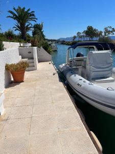a boat is docked at a dock in the water at Villa Maria in Thermisía
