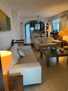 a living room with couches and a coffee table at Villa Maria-Stunning Villa in Porto Hydra in Thermisía