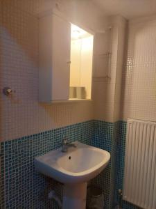 uma casa de banho com um lavatório e um espelho em Ρετρό Κλινάρι em Xanthi