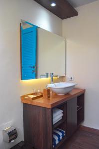 a bathroom with a sink and a mirror at The MG Villa & SPA in Nusa Penida