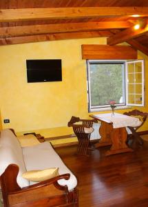 a living room with a couch and a table and a television at B&B Ca dei Fre in Genova +15 photos