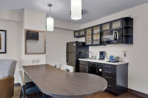 cocina con mesa y encimera en Candlewood Suites Erie, an IHG Hotel, en Erie