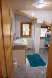 a bathroom with a sink and a mirror at Ferienhaus Mühlstein in Silbertal