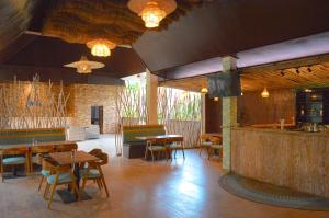a restaurant with tables and chairs and a bar at The MG Villa & SPA in Nusa Penida