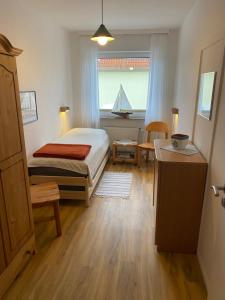 a bedroom with a bed and a window at Haus Potosi, Travemünde in Lübeck