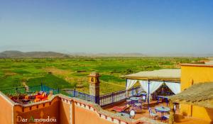 a balcony of a building with a view of a field at Dar Amoudou in Ouarzazate
