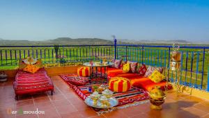 a patio with pumpkins and a table and chairs at Dar Amoudou in Ouarzazate