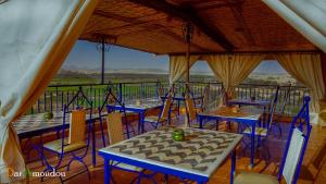 a group of tables and chairs on a balcony at Dar Amoudou in Ouarzazate