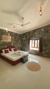 a bedroom with a large bed and a window at Jabal Shams Mountain Rest House in Al Hūb