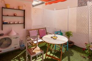 サンタクルス・デ・テネリフェにあるLas Américas, apartamento a 150 mts de la Playaの小さな客室で、テーブル、椅子、電子レンジが備わります。