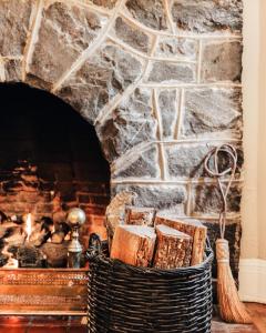 a basket of bread in front of a stone fireplace at Princess Anne Boutique Hotel & Breakfast in Asheville
