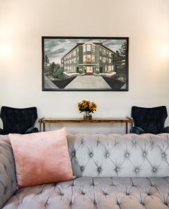 a couch in a living room with a picture on the wall at Princess Anne Boutique Hotel & Breakfast in Asheville