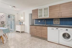 a kitchen with a washer and dryer in it at Casa Julia in Playa de las Americas