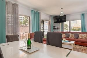 a living room with a table and a couch at Casa Julia in Playa de las Americas