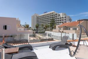 a patio with chairs and a view of a building at Casa Julia in Playa de las Americas