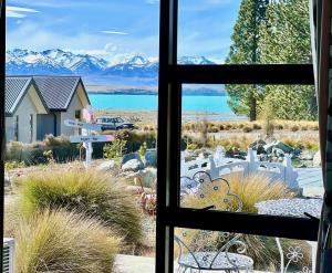 a view from a window of a house with mountains at Alice Garden in Lake Tekapo