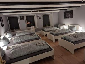 a room with four beds and two windows at Flensburg Zentrum 69 05 in Flensburg
