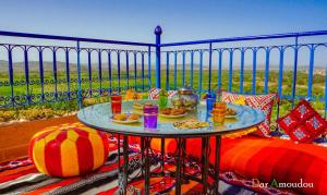a table with plates of food on a balcony at Dar Amoudou in Ouarzazate