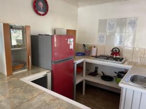 a kitchen with a red refrigerator in a room at Cabañas Pankara in San Pedro de Atacama