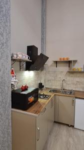 a kitchen with a sink and a counter top at Kheta Apartments Kazbegi in Kazbegi +24 photos