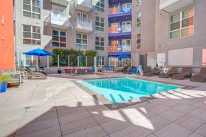 a swimming pool in front of a building at Centrally Located Apartments with Free parking in Glendale