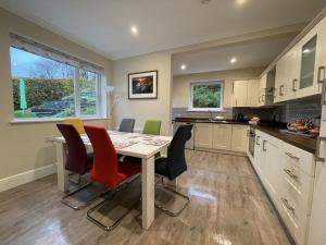 a kitchen with a dining room table and chairs at Three Peaks in Braithwaite