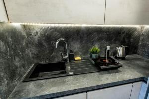 a kitchen counter top with a sink and a sink at Apartmán Strieborná v centre mesta in Banská Bystrica