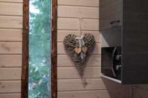 a heart decoration on a wall next to a stove at Unique Cabin with Breathtaking Northern Light View in Rovaniemi