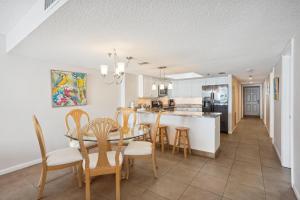 a kitchen and dining room with a table and chairs at Las Brisas 202 in St. Pete Beach