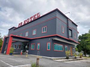 a large blue building with a hotel sign on it at Pz Hotel in Kuala Kangsar