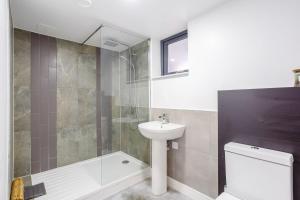 a bathroom with a shower and a sink and a toilet at Svarga Mountain View in Kinlochleven