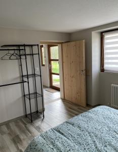 a bedroom with a room with a bed and a ladder at l'ECURIE pour 6 personnes in Lebétain