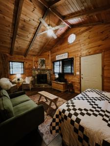 a bedroom with a bed and a couch and a fireplace at Sylvan Valley Lodge and Cellars in Sautee Nacoochee