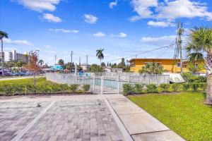 a park with a fence and palm trees at Madeira Del Mar 205 in St. Pete Beach