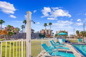 a group of blue chairs next to a pool at Madeira Del Mar 205 in St Pete Beach