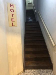 a flight of stairs with a sign on the wall at Hotel Popular Vila Mariana in Sao Paulo