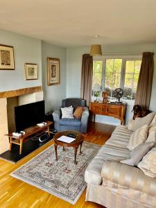 a living room with a couch and a table at Spacious home in Bath, nature and city! in Bath