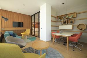 a living room with a table and chairs at Holiday Inn Skopje by IHG in Skopje