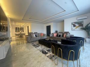 a large living room with a couch and chairs at Romel Terraces in Lagos