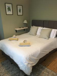 a large bed with two trays on top of it at St Mary's Cottage in Boston Spa