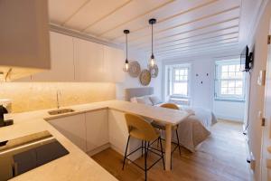 a kitchen and living room with a table and chairs at New Lisbon Center Apartment in Lisbon