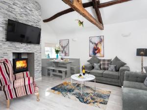 a living room with a couch and a fireplace at Highgate in Kirklinton