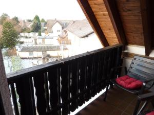 a balcony with a chair and a view of a house at Hotel Ockenheim in Ockenheim