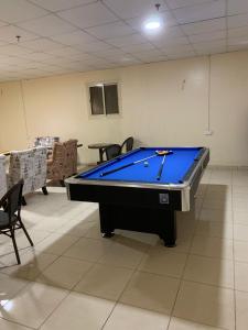 a large pool table in a room with chairs at حلول 9 in Abyār ‘Alī
