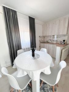 a white table with white chairs in a kitchen at My sweet home Vrhpraca Jahorina in Jahorina