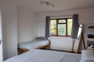 a bedroom with two beds and a window at Mickleover House-Large Detatched Family House in Derby