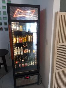 a refrigerator filled with lots of bottles of beer at Pousada Aconchego in Aracaju