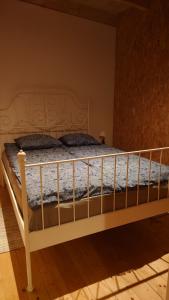 a bed in a bedroom with a wooden floor at Apartamenty STONEHENGE in Sosnowiec