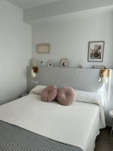 a bedroom with a bed with two pillows on it at Fantastic apartment a few meters from the beach in the center of Estartit in L'Estartit